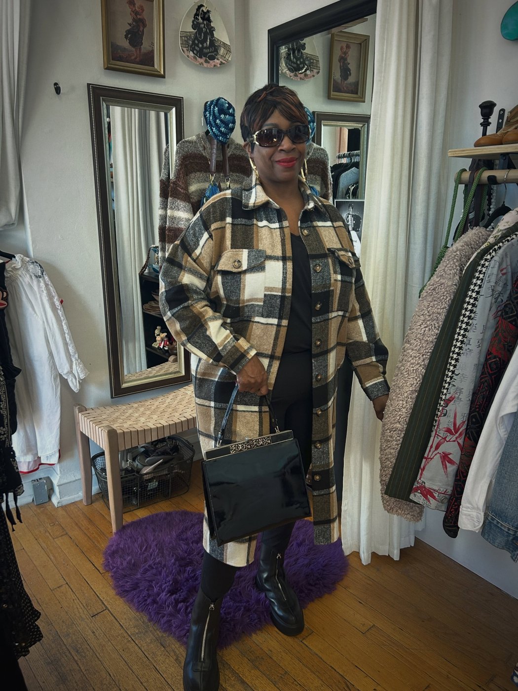 A shop customer with a black vintage handbag with a decorative clasp